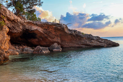 Rock formation in sea against sky