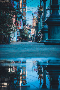 People walking on street by buildings in city