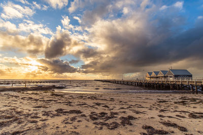 Scenic view of beach against sky during sunset