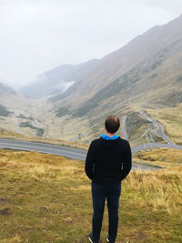 Rear view of man looking at mountains