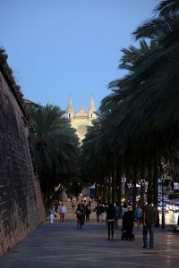 People at temple against clear sky