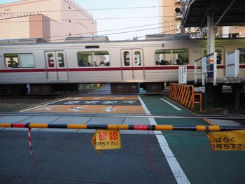 Railroad crossing by train in city