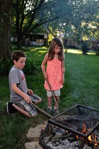 Happy girl with arms outstretched on barbecue