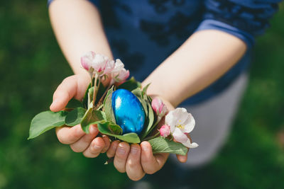 Midsection of woman holding easter egg