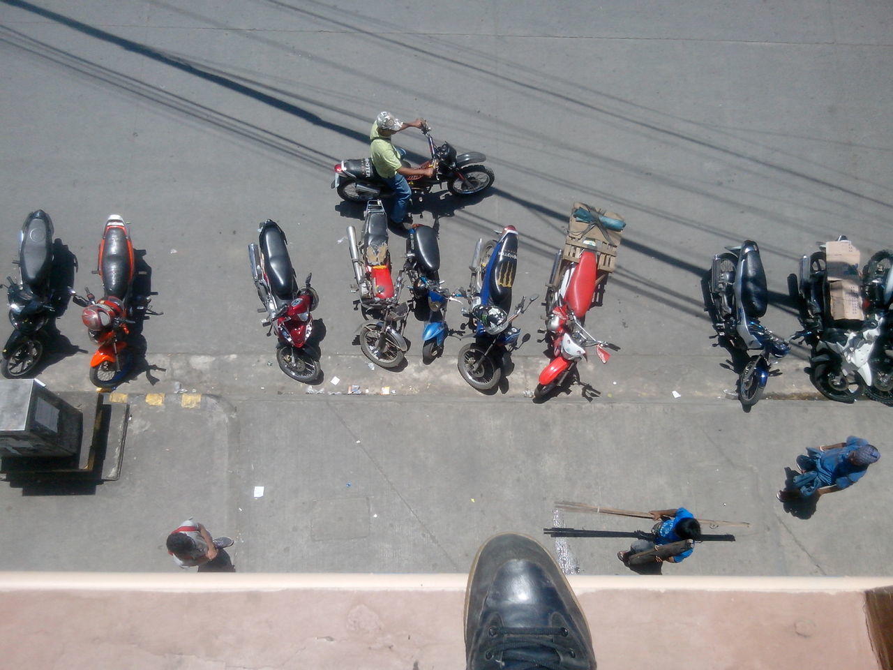 bicycle, transportation, land vehicle, mode of transport, high angle view, men, motorcycle, large group of people, street, parked, stationary, person, parking, lifestyles, travel, leisure activity, riding, day, road