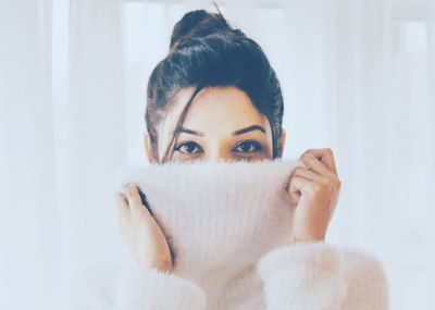 Close-up portrait of woman holding hands