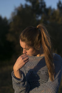 Midsection of woman looking at camera during winter