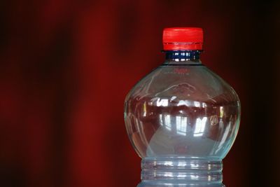 Close-up of light bulb on table against wall
