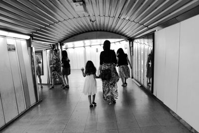 Rear view of man walking in corridor
