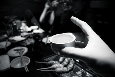 Cropped hand of woman holding coffee