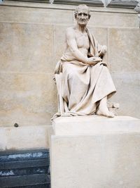 Statue in front of concrete outdoors