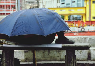 Woman holding umbrella in city