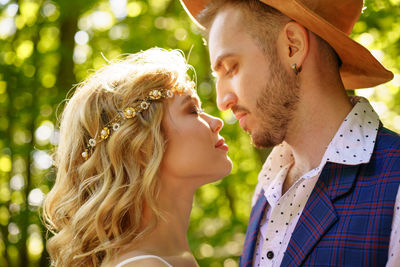 Portrait of young couple kissing outdoors