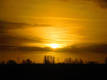 Scenic view of silhouette landscape against romantic sky at sunset