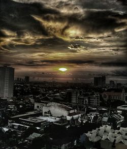 Cityscape against cloudy sky