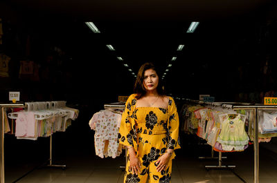 Portrait of young woman standing in store