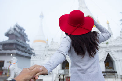 A young tourist visit wat phra that doi kong mu on a foggy day, mae hong son province, thailand.