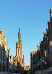 View of buildings against clear blue sky