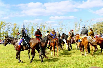 Horses on field against sky