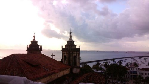 Buildings against cloudy sky at sunset