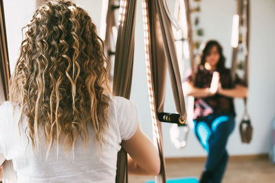 Rear view of a girl meditating after a yoga class