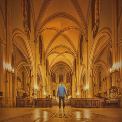 Rear view of man standing in cathedral