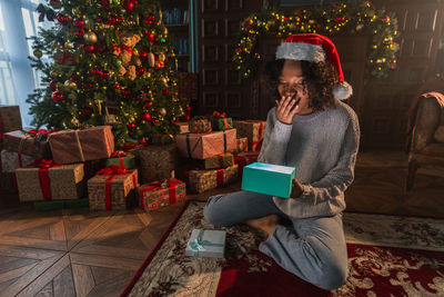 Rear view of woman sitting on sofa at home