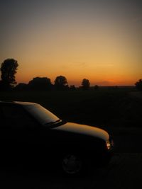 Car on road against sky during sunset