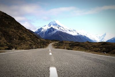 Empty road passing through mountains