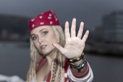 Blonde woman with dreadlocks ordering to stop