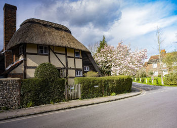 Road by building against sky