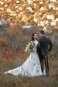 Side view of woman holding bouquet