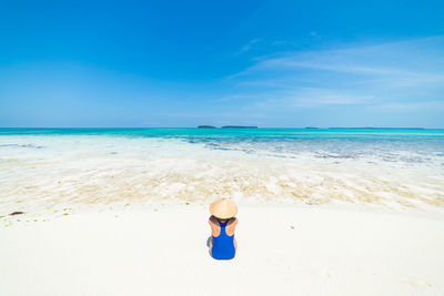 Full length of woman on beach against sky