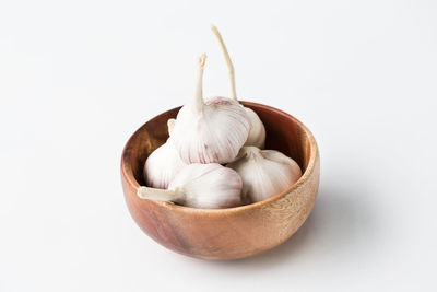 Close-up of eggs in bowl against white background