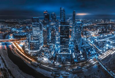 High angle view of illuminated buildings against sky at night