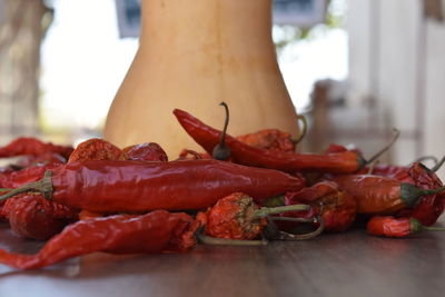 Close-up of red chili peppers on table