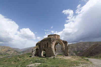 Old ruins of mountain against cloudy sky