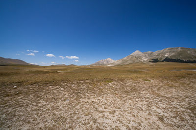 Scenic view of mountains against clear blue sky