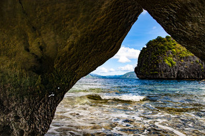 Scenic view of sea seen through cave