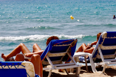 People relaxing on beach