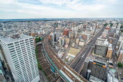 High angle view of modern buildings in city against sky