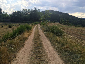 Empty road along countryside landscape