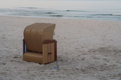 Chair on sand at beach