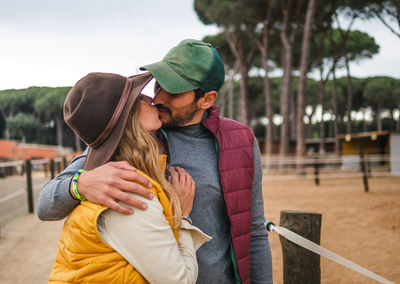 Young couple holding hands while standing outdoors