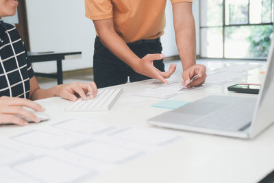 Low section of people working on table