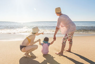 Full length of father and son on beach