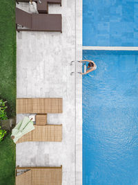 Aerial view of attractive woman near the pool at resort