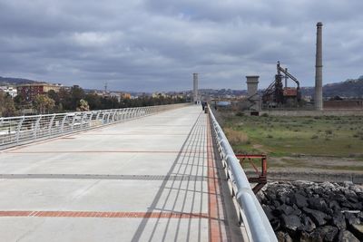 View of railroad tracks against cloudy sky