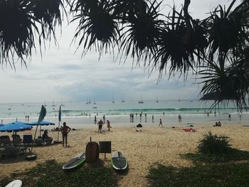 People on beach against sky