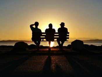 Silhouette of people at sunset